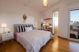 a bedroom with a bed and a desk and a window at D09 - Porto de Mós Luxury Villa in Lagos