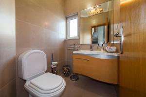 a bathroom with a toilet and a sink and a mirror at D09 - Porto de Mós Luxury Villa in Lagos