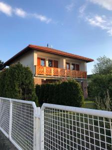 a house with a fence in front of it at Lilla Villa in Siófok