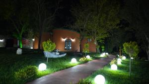 a garden at night with lights in the grass at Kule Hotel Airport in Arnavutköy
