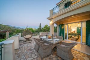 a patio with a table and chairs on a balcony at Eglina Villa's in Minia