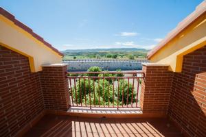 a balcony with a view of the water at Hotel Torcal in Guadalajara