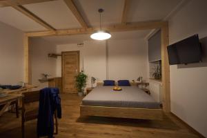 a bedroom with a bed in a room with a table at Apartamenty Ponidzie in Busko-Zdrój