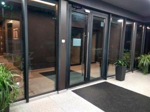 a group of glass doors in a building at Sky House Panorama MAIN STREET Chisinau in Chişinău