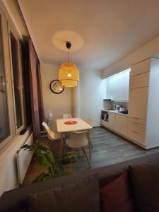 a small kitchen with a table and a dining room at Home Away Center Kuopio in Kuopio