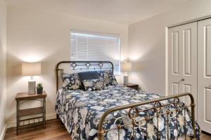 a bedroom with a bed with a blue bedspread and a window at 5J Top Floor RedCliff Condo, Pool & Hot Tub in Moab +5 photos