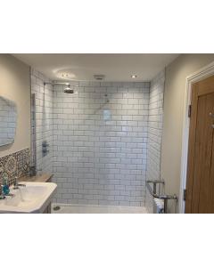 a bathroom with a sink and a white brick wall at The Woad Mill in Boston