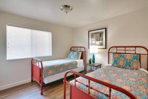 a bedroom with two beds and a window at 5K Top Floor RedCliff Condo, Pool & Hot Tub in Moab