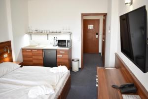 ein Hotelzimmer mit einem Bett und einem Flachbild-TV in der Unterkunft Lipno Wellness - Frymburk C 402-403 in Frymburk