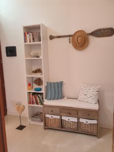 a room with a bench and a book shelf at Cottage al mare Martina in Venice-Lido