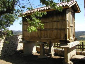 a wooden bird house sitting on a stone stand at Casa de Campos in Silleda +7 photos