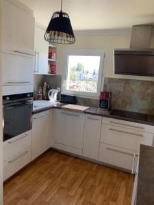 a kitchen with white cabinets and a window at 65 m2 Centre vannes 2 ch wifi parking in Vannes