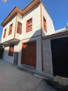 a house with wooden doors and a garage at Mariana Konak in Antalya