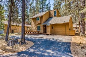 a large yellow house with a garage at 2 Conifer in Sunriver