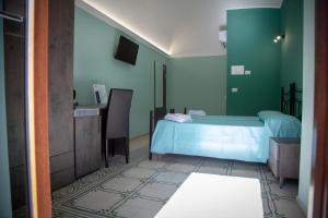 a bedroom with a blue bed and a sink at Al Centro Casa Vacanze in Mistretta
