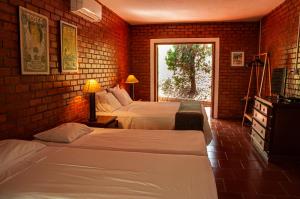 Säng eller sängar i ett rum på Hotel Bougainville