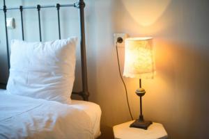a bedroom with a bed with a lamp on a night stand at Oikies Katogi in Pramanta