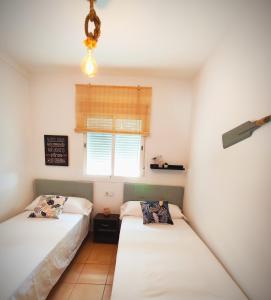 Posteľ alebo postele v izbe v ubytovaní El ático de los flamencos, Apartamentos Living Sur + 18 fotografií