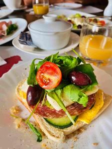 a sandwich with a tomato and lettuce on a plate at Ta Paolo in Qala