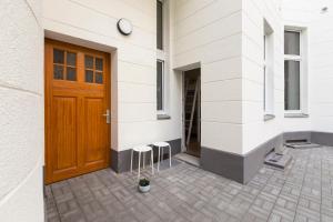 a door of a building with two stools next to it at Feels like Home in Berlin