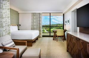 a hotel room with a large bed and a large window at Hyatt Regency Maui Resort & Spa in Lahaina