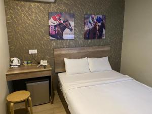 Postel nebo postele na pokoji v ubytování SH Hotel Kota Damansara