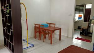 a room with a table and two chairs and a mop at Ms Homestay jeli in Jeli