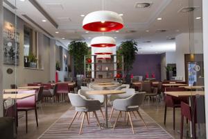 a restaurant with tables and chairs and a red light at Staybridge Suites Birmingham by IHG in Birmingham