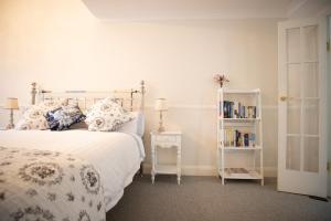 a bedroom with a bed and a book shelf at Canungra Cottages - Boutique Bed and Breakfast in Canungra
