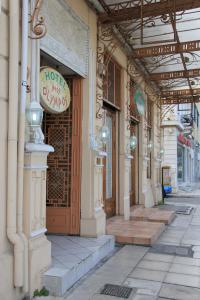 a building with a sign on the side of a street at Hotel Neos Olympos in Athens