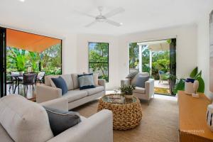 a living room with couches and a table at Quay Largo Apartment 2, Noosaville in Noosaville