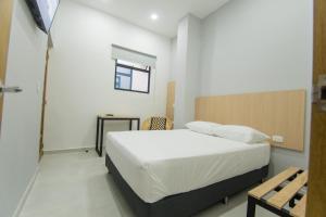 Stanza Hotel Sincelejo客房内的一张或多张床位