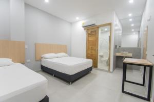 Stanza Hotel Sincelejo客房内的一张或多张床位
