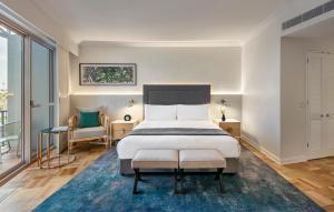a bedroom with a large bed and a blue rug at InterContinental Sanctuary Cove Resort, an IHG Hotel in Gold Coast