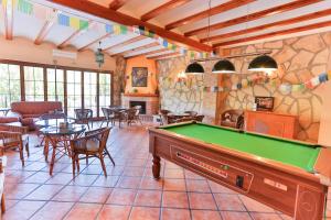 a pool table in a living room with a billiard room at Hotel Rural Serrella in Castell de Castells