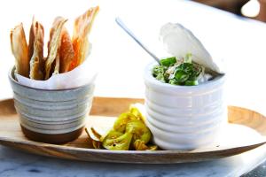 a plate of food with a salad and french fries at Kimpton Journeyman Hotel, an IHG Hotel in Milwaukee