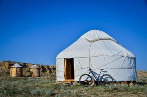 a bike parked in a yurt in a field at Feel Nomad Yurt Camp in Ak-Say