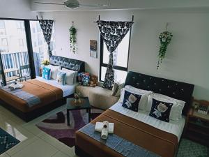 Postelja oz. postelje v sobi nastanitve D'Gunduls Homestay STUDIO by DGH I-CITY