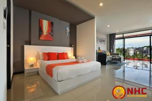 a bedroom with a large bed with red pillows at Nai Harn Condominium in Nai Harn Beach