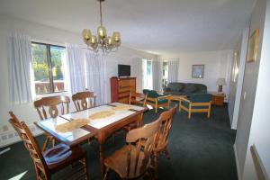 a dining room and living room with a table and chairs at Bighorn Inn & Suites in Canmore