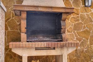 a stone pizza oven in a stone wall at Villa Pintor in Port de Pollensa