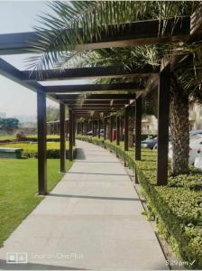 a walkway in a park with a blue canopy at Entire Condominium Luxury Suites Perfect Getaway in Noida +22 photos