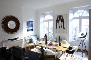 a living room with a table and chairs at Maison Eugénie in Luchon