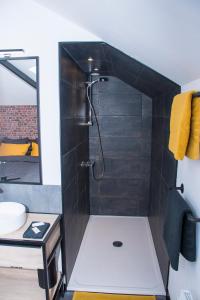a bathroom with a shower with a sink at Meublé de tourisme 3 étoiles Loft industriel à Fismes in Fismes