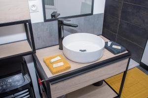 a bathroom with a white sink on a counter at Meublé de tourisme 3 étoiles Loft industriel à Fismes in Fismes +11 photos