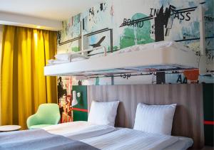 a bedroom with two beds and a wall with graffiti at Good Morning Arlanda in Arlanda