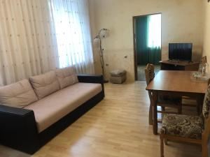 a living room with a couch and a table at Zhemchuzhina Kavkaza Hotel in Zheleznovodsk