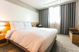 Postel nebo postele na pokoji v ubytování ON City Hotel