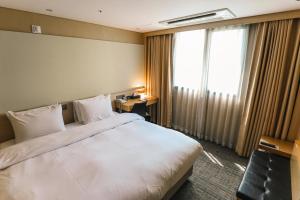 Postel nebo postele na pokoji v ubytování ON City Hotel