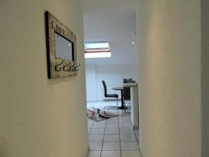 a hallway with a table and a chair in a room at Monteurwohnung Monti 1 in Saarbrücken